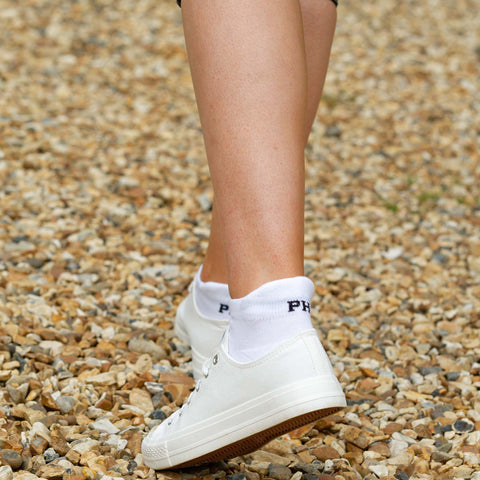Woman wearing white trainers and white Trainer Sport socks from Peper Harow