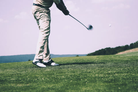 Man swinging a golf club.