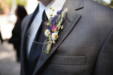 Man wearing boutonniere at wedding.