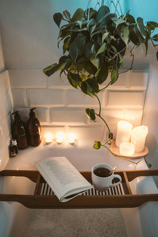 A relaxing bubble bath featuring a book and tea