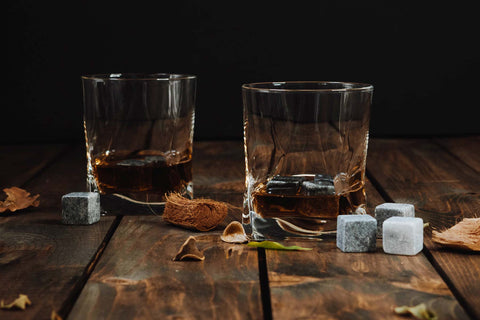 Two glasses of whisky with reusable ice blocks on a table