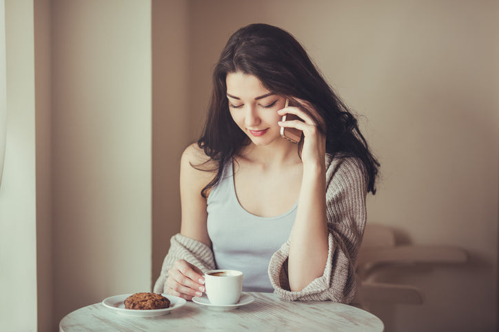 カフェでスマホを持つ女性