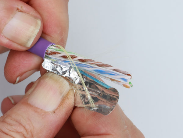 peeling off the foil shield on a shielded cable