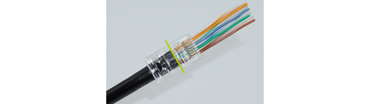 Fully insert the cable jacket into the plug. Seat --at a minimum-- to the green line as indicated. Alternate between pulling on the conductors and pushing on the cable jacket.