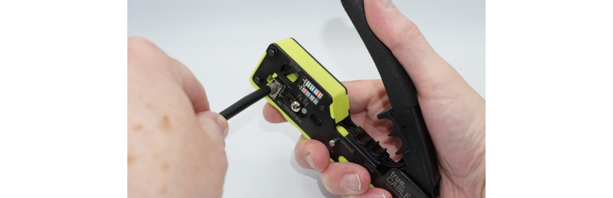 Insert plug and cable assembly into the trueCRIMP tool. Use only light pressure and then press the tool lever fully downward.