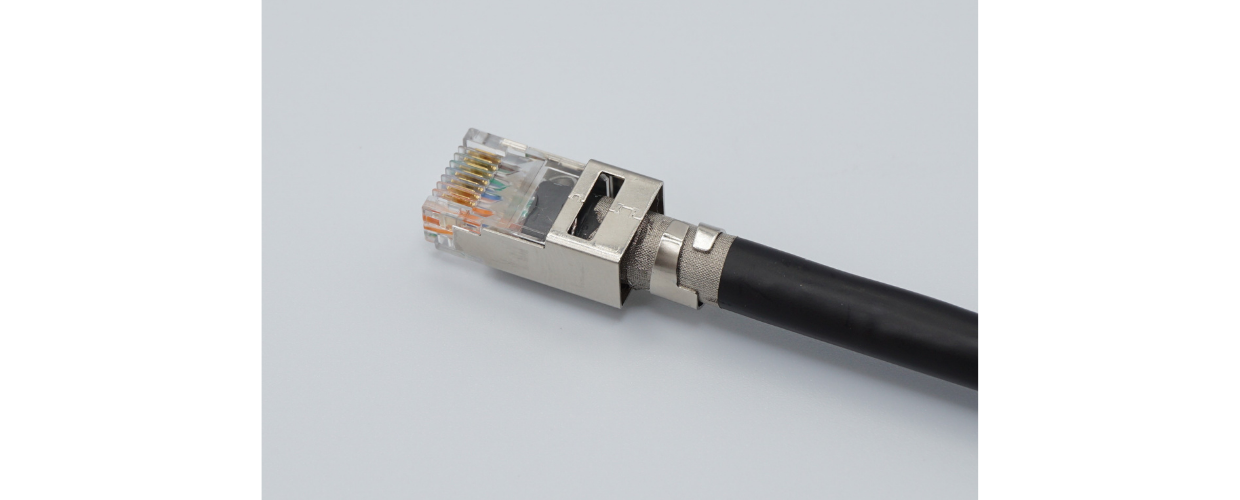 External ground RJ45 plug termination. Notice how the strip does not go to the end of the cable jacket and the ground tabs are crimped firmly around the strip?