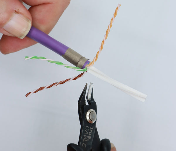 Remove the spline by making four snips. Rest the clippers on the cable jacket edge and snip each “wing” downwards. Be careful not to nick a conductor. DO NOT remove the spline by cutting straight across--it will make termination more difficult.