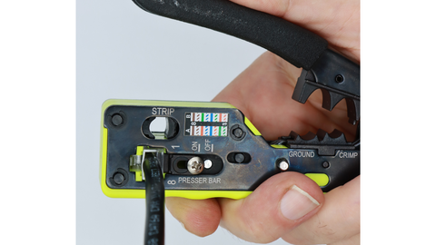 Insert the RJ45 plug and cable assembly into the All-In-One Crimp & Termination Tool and terminate the golden contacts