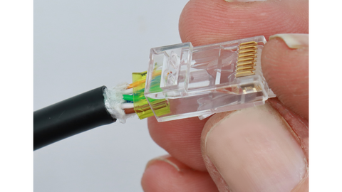 Insert cable and load bar assembly into plug housing.  Note orientation of the load bar in relation to the plug housing and conductor colors.  This is a T568B termination.