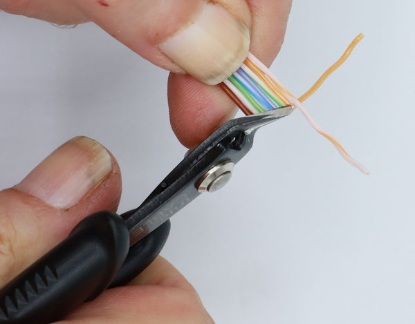 Line up the conductors and then flush cut about ½” off.  Leave about 1.5” of conductor excess.  You may cut straight across or on an angle as you prefer.  Once the conductors are in sequence and flush cut, maintain control of the conductors or they will get out of sequence!