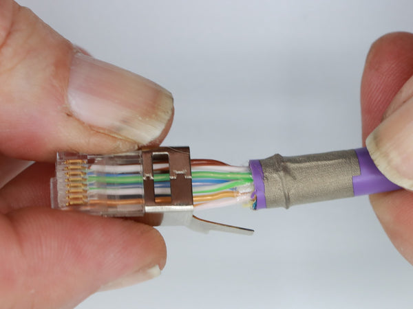 Begin inserting the conductors into the plug housing