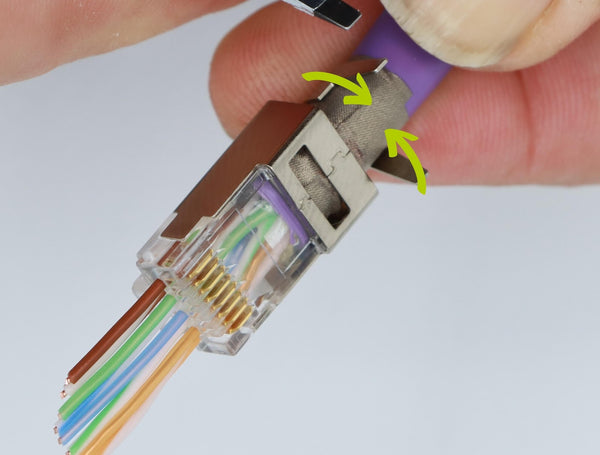 diagram showing how to fold in the ground collar wings on a shielded rj45 connector