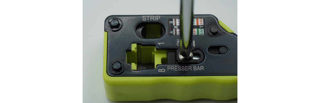 The strain latch presser bar in the OFF position.