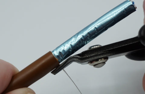 Flush cut the nylon ripcord at the cable jacket edge