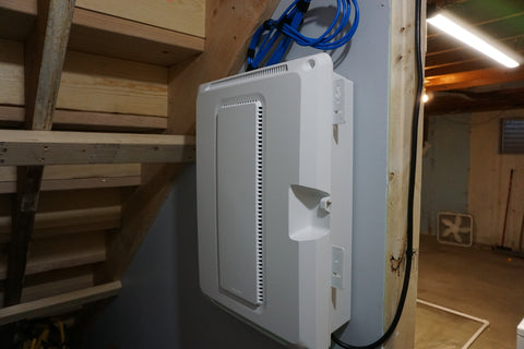a photo of service slack above a patch panel setup inside a residential home
