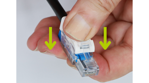 Pushing the tabs down on the field termination connector to terminate a direct burial cable