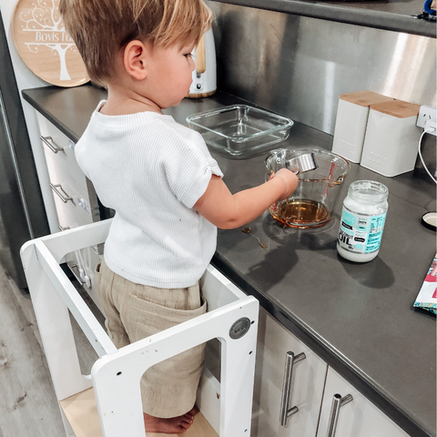 Child measuring while cooking