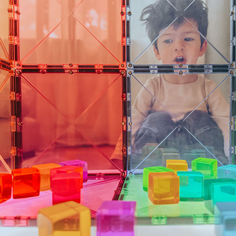 Child looking through Magnetic Tile