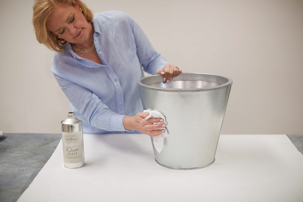 Make your own aged zinc bucket for your home or garden. All you need is a bucket, some Zinc Antiquing Solution, a rag, and some gold leaf. See step by step instructions for this DIY zinc bucket project.