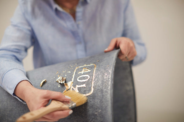 Make your own aged zinc bucket for your home or garden. All you need is a bucket, some Zinc Antiquing Solution, a rag, and some gold leaf. See step by step instructions for this DIY zinc bucket project.