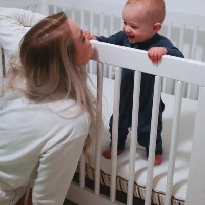 Mother and her baby in the organic crib mattress