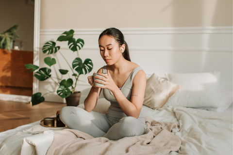 Woman meditating while sitting on her wellness mattress