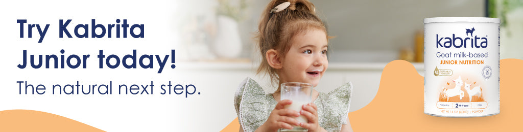 Banner of a little girl enjoying a glass of Kabrita Junior with a milk moustache