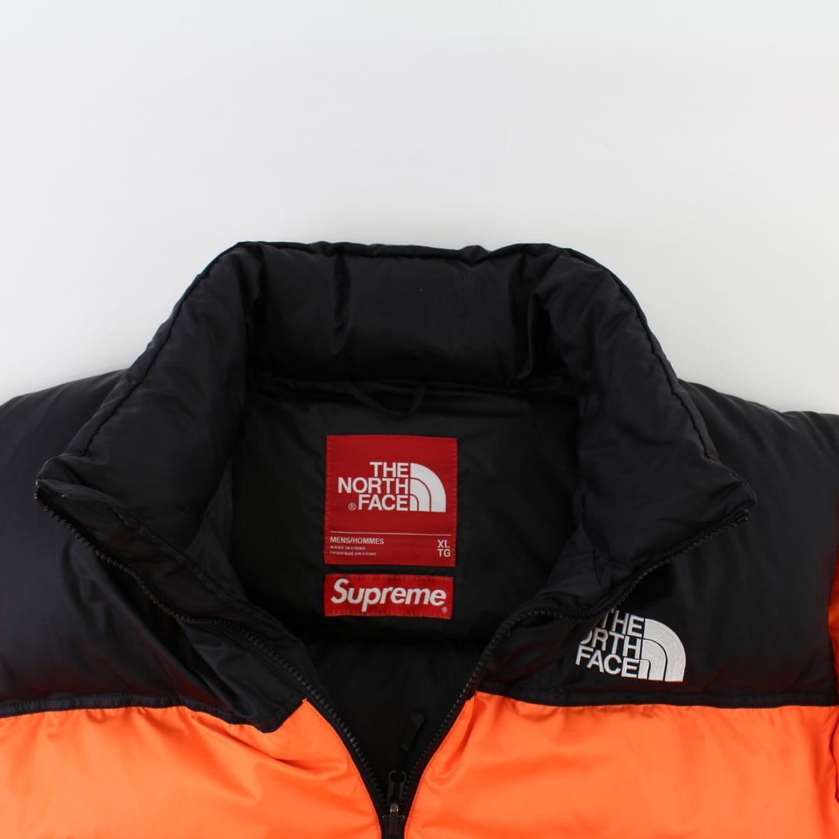 orange north face supreme jacket