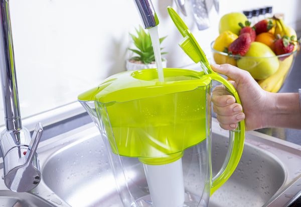 Woman Filling Water Filter Pitcher
