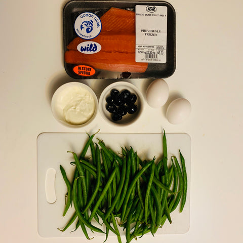 Ingredients for Salmon Nicoise salad. Salmon, green beans, eggs, olives, yogurt