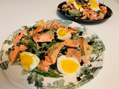 Two plates of salmon nicoise salad