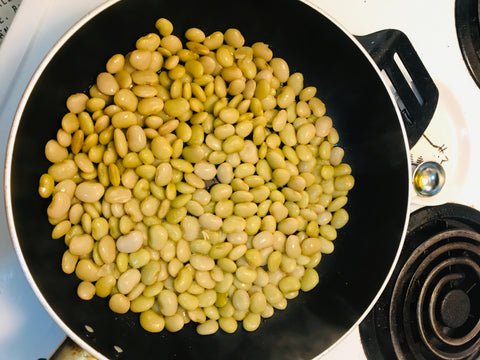 Lima beans cooking in a pan