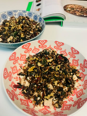 Two bowls of cherry chard wild rice salad with the Jamie Oliver cookbook in the background