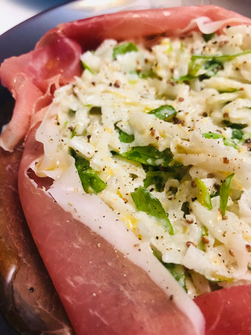 Close up of a plate of prosciutto celeriac salad