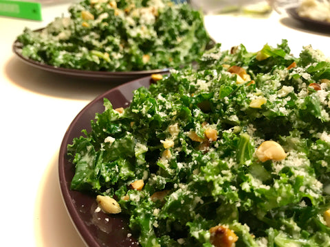 Two plates of nutty kale salad