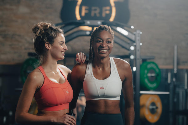 Women laughing in the gym while working out