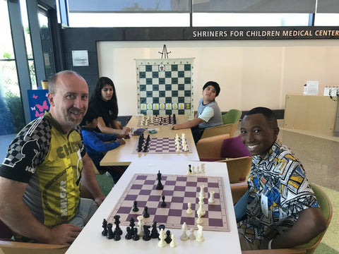 Shelby playing chess at Shriner's Children's Hospital with Sean's Fund Coach Jay 