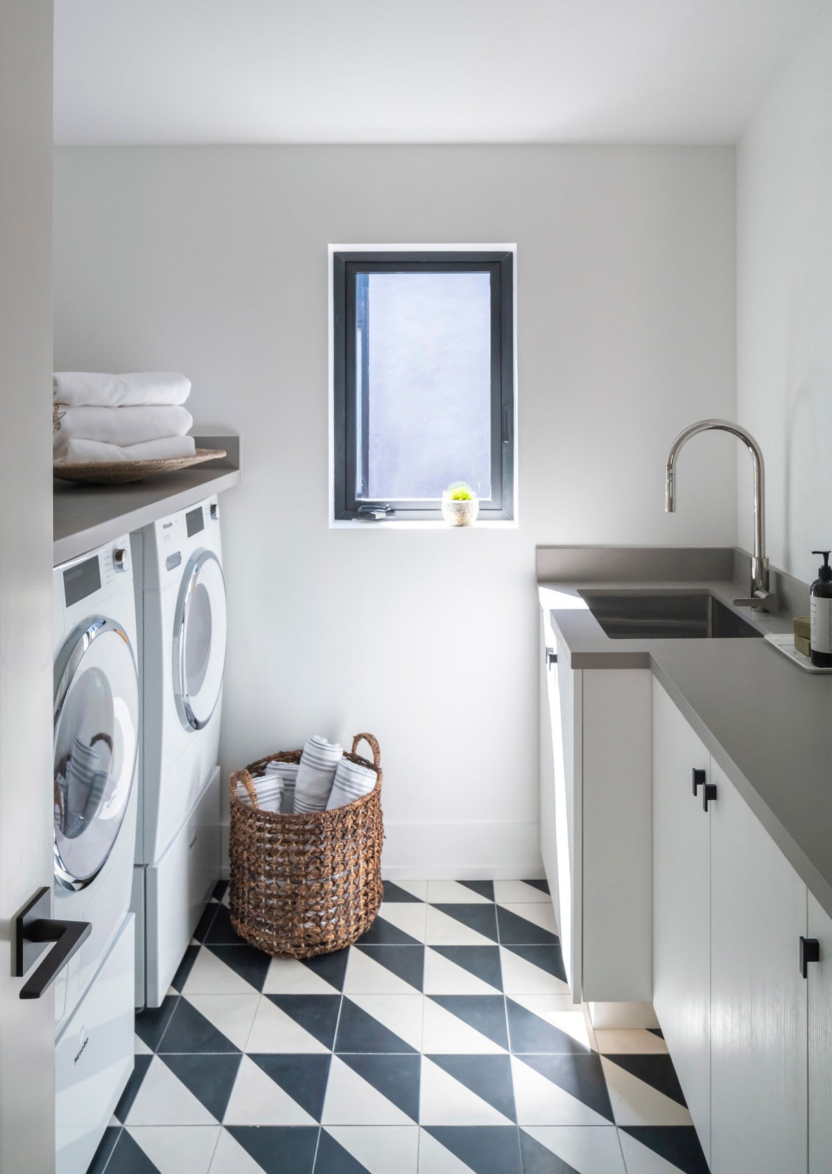 Two black and white cement tile floors, one with a geometric pattern and one with a wavy pattern.