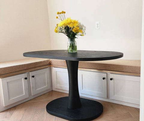 A Black Ash Dining Table on a Banquette Table