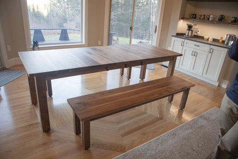 walnut table and bench on parker base