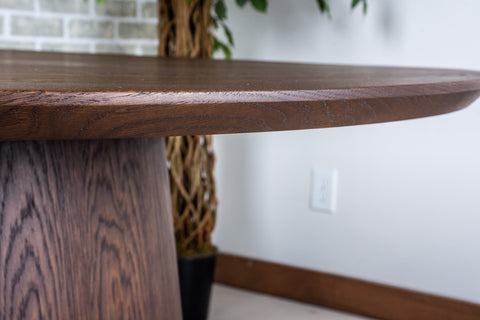 an oak dining table with an espresso finish