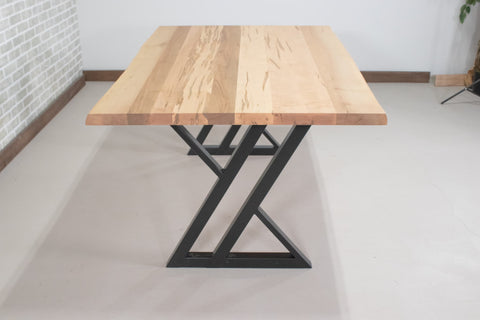 black zionz legs under a natural maple table