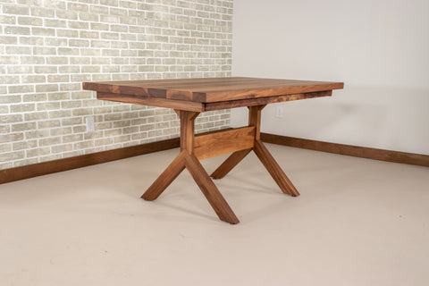 yoder table base in walnut under a walnut extendable table