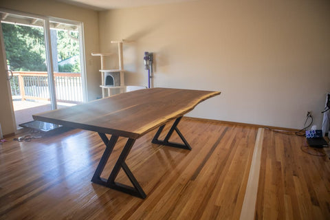 black zionz legs under a walnut dining table