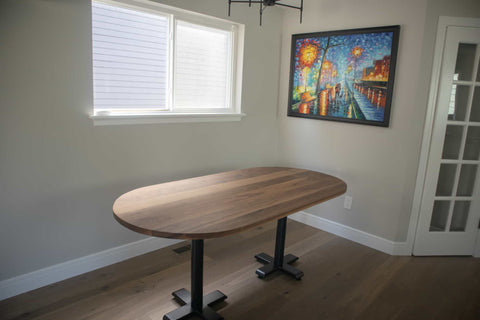 2 bidwell bases under an oval walnut table