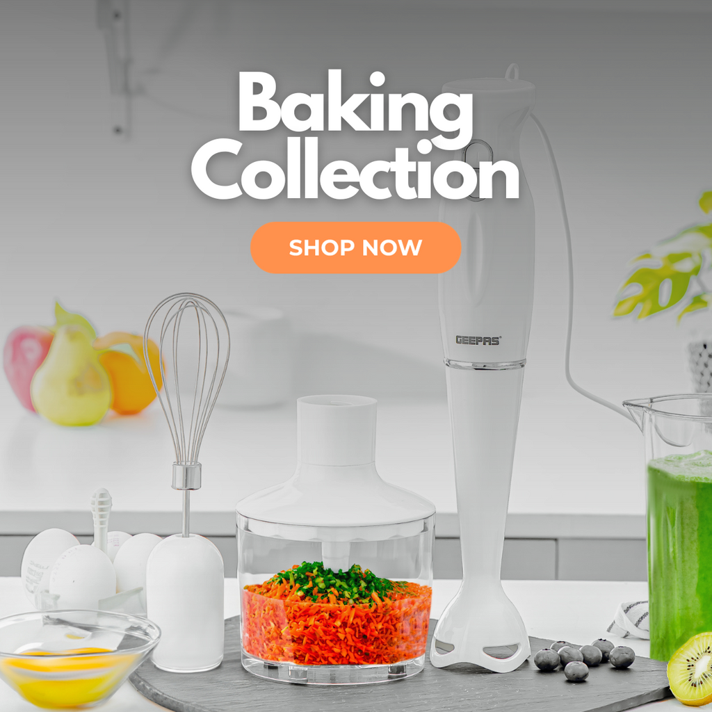 A 3-in-1 hand blender on top of a kitchen countertop, with different foods prepared and processed in the blender such as a smoothie and shredded veggies.