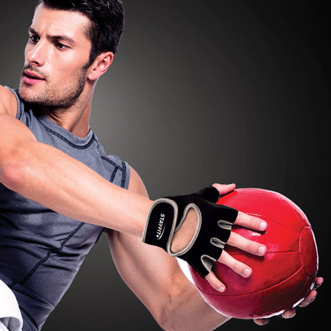 Male athlete wearing fitness gloves holding a medicine ball
