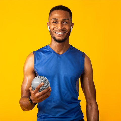 Male athlete holding a massage ball