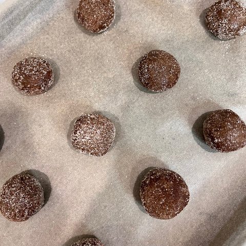 Gingersnap cookies rolled into balls dusted with white sugar