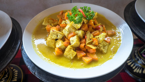 Bowl of curry with pumpkin, tofu, carrots